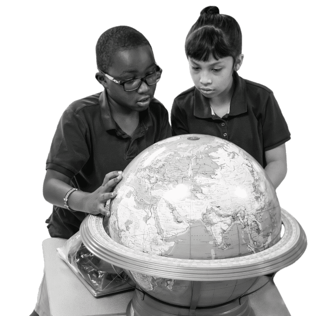 Two students examining a globe