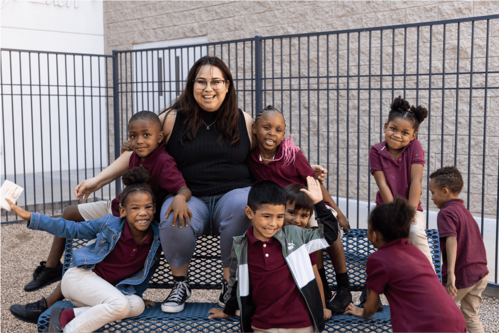 A teacher surrounded by her students