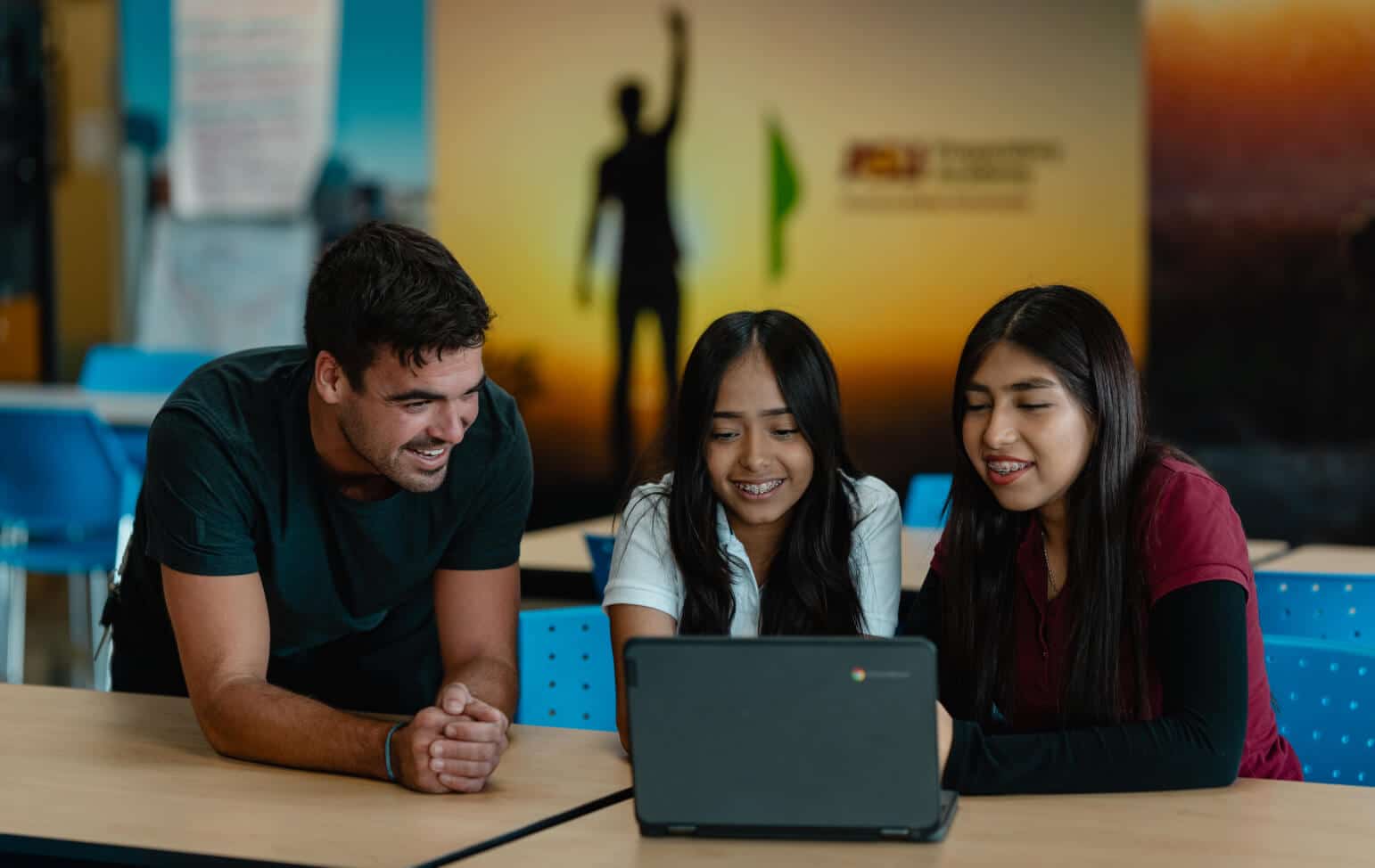 Students and faculty learning on a laptop