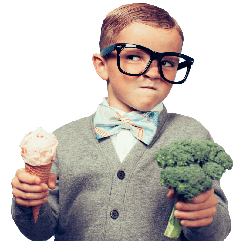 Little boy wearing oversized eyeglasses and a bowtie, making a mean face while holding an ice-cream in one hand and broccoli in the other hand.